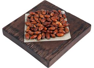 Honey roasted almonds on red brown serving board