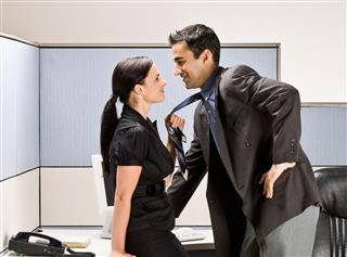 Co-workers Kissing in Office