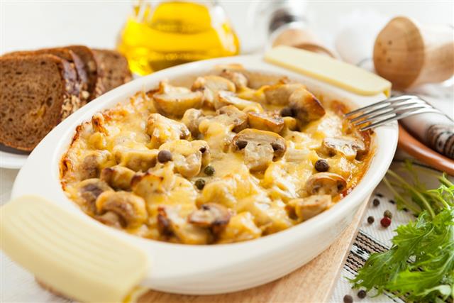 Vegetables casserole with mushrooms, potatoes and cheese closeup
