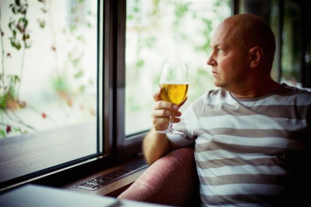 Mature Man drinking beer alone