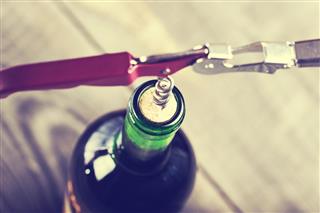 open wine bottle with corkscrew