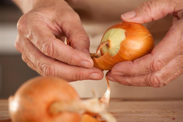 Close up peeling onion