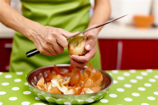 Woman peeling onions