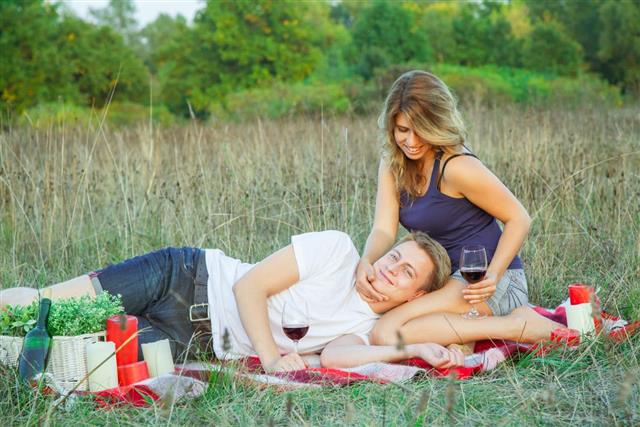 Lovely young beautiful couple resting in park