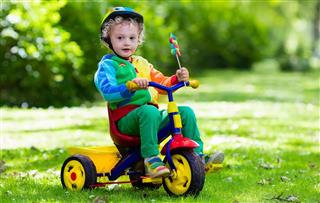 Little boy on colorful tricycle
