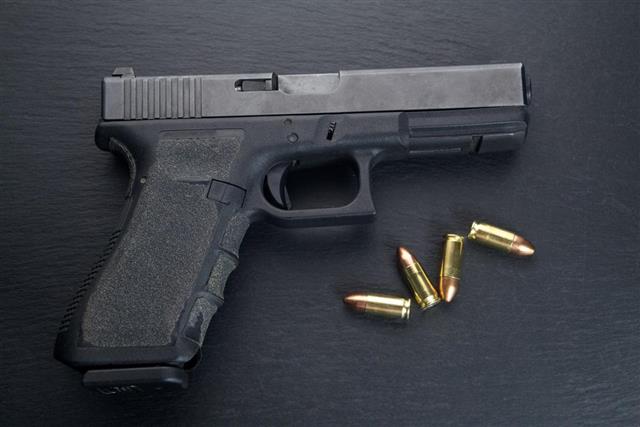 Pistol gun on black background