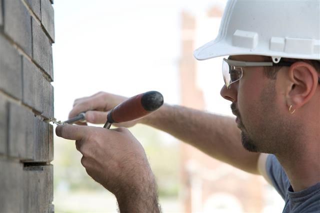 Construction mason pointing brick joints