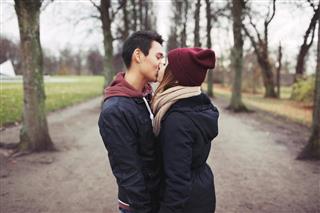 Teenage couple kissing outdoor in the park