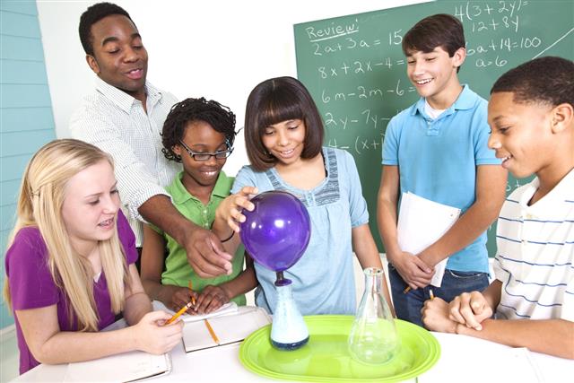 Junior High students in science class watching balloon blow up