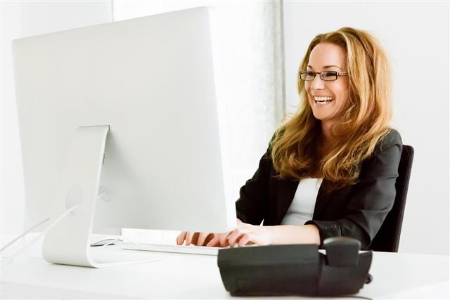 Having fun businesswoman laughing reading messages