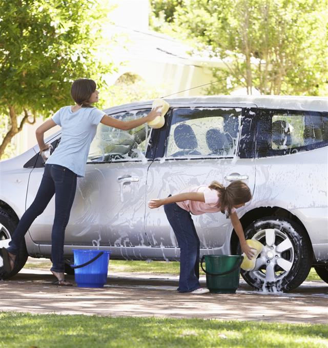 Two Girls Washing Car Together