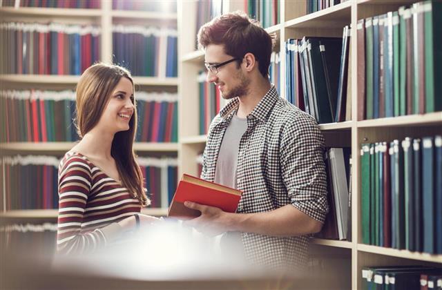 Smiling couple talking in a library
