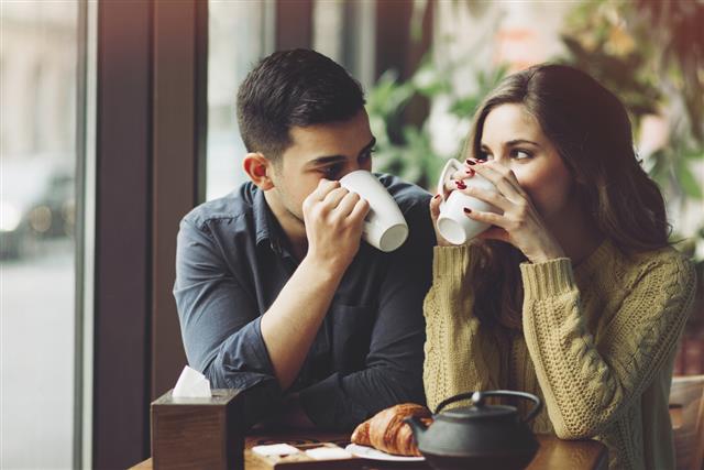 Couple in love drinking coffee in coffee shop