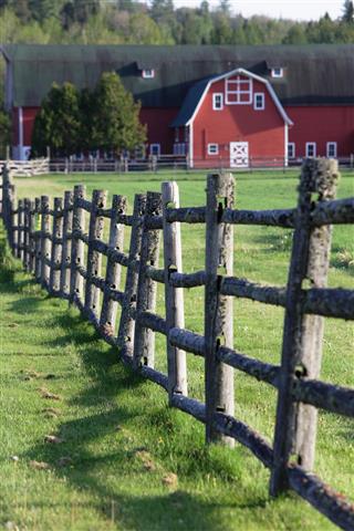 Rustic Wooden Fence and Distant Red Barn