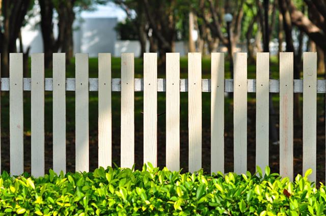 White fence in front of garden
