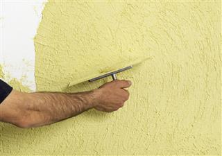 Applying plaster on a wall