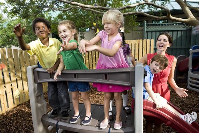 Four preschoolers in playground