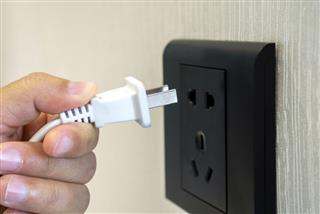 Hand inserting electricity plug
