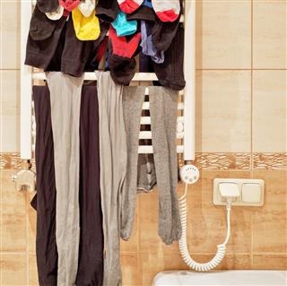 Socks and leggings drying on bathroom radiator