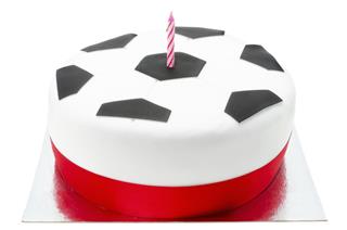 Birthday cake decorated like a football with candle