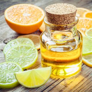 Citrus essential oil and slice of ripe fruits