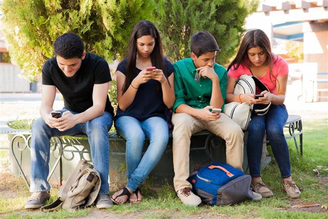 Teens busy with cell phones
