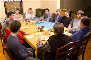 Multiple people sitting around dinner table