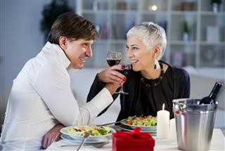 Beautiful mature - senior couple have romantic dinner at home