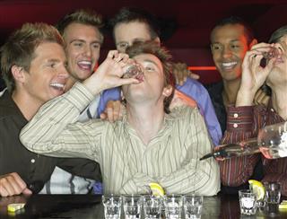 Men drinking shots at a bar