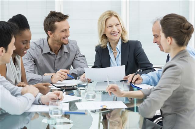 Smiling business people in a meeting at a table