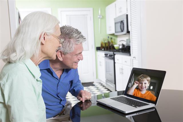 Senior Couple Video Chatting with Grandchild