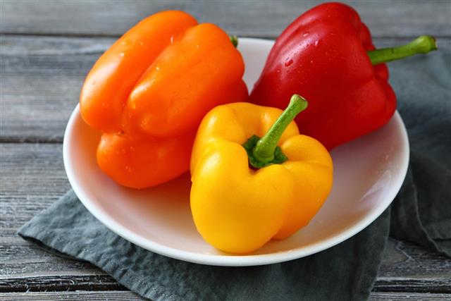 Colorful peppers on a white plate