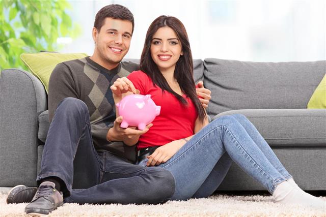 Young Couple Posing with Piggy Bank
