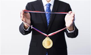 Businessman giving gold medal