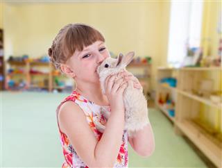 Girl kissing a pet rabbit