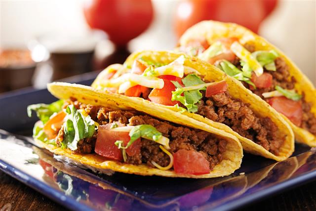 three beef tacos with cheese