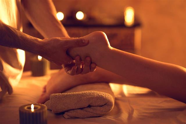therapist massaging woman foot