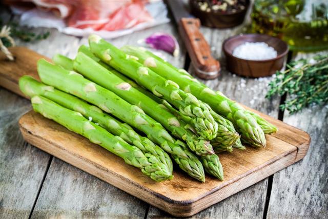 Fresh organic asparagus on a cutting board