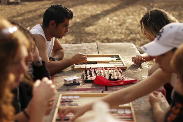 Young people playing checkers outdoor