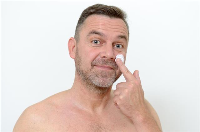 Man Applying Moisturizer on Face