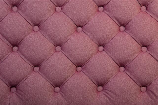 Pink tufted fabric upholstery texture