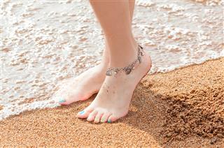 Legs of a young girl and anklet ankle