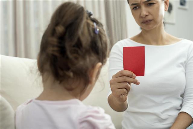 Mother is Showing Red Card to Child