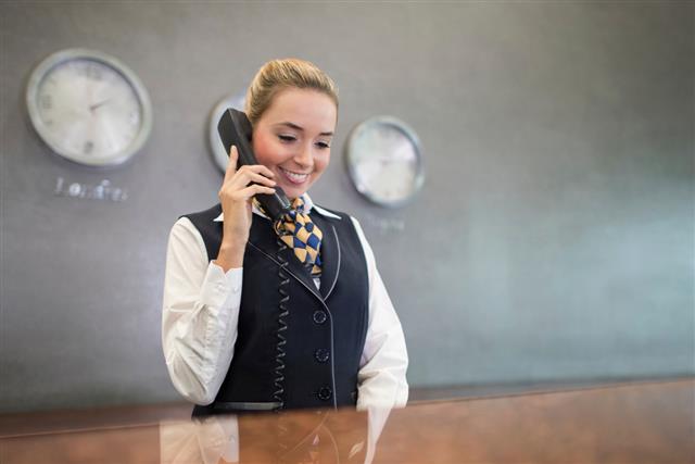 Woman working at the front desk of a hotel