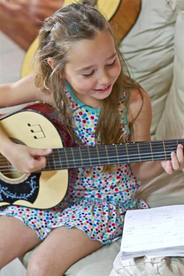Young girl playing guitar