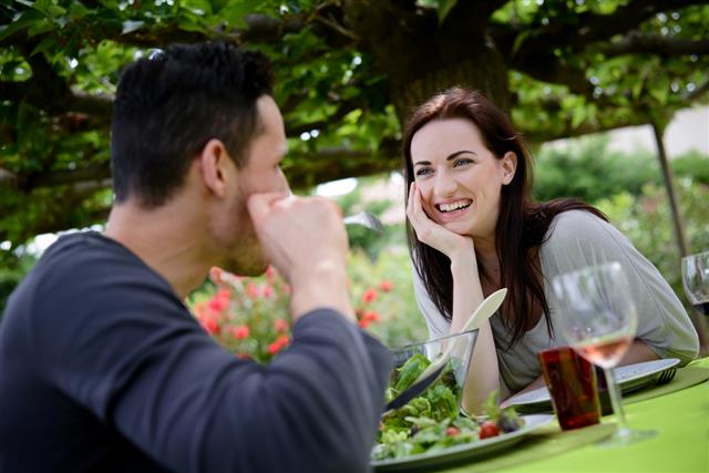 Happy young loving couple having lunch barbecue party outdoor garden