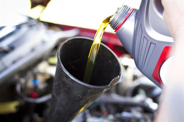 Pouring Oil into Car