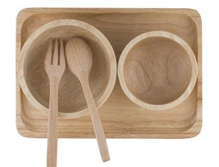 Wooden spoon and cup placed on wooden tray