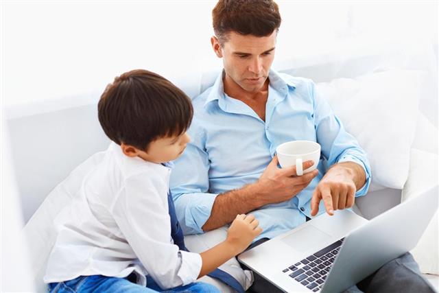 Home education. Father helping his son to do his homework