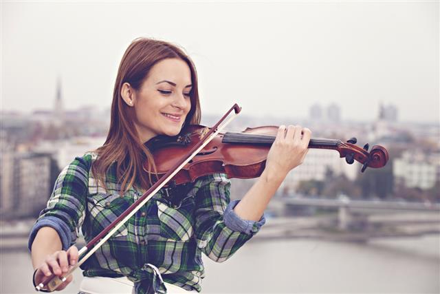 Woman playing violin outdoors